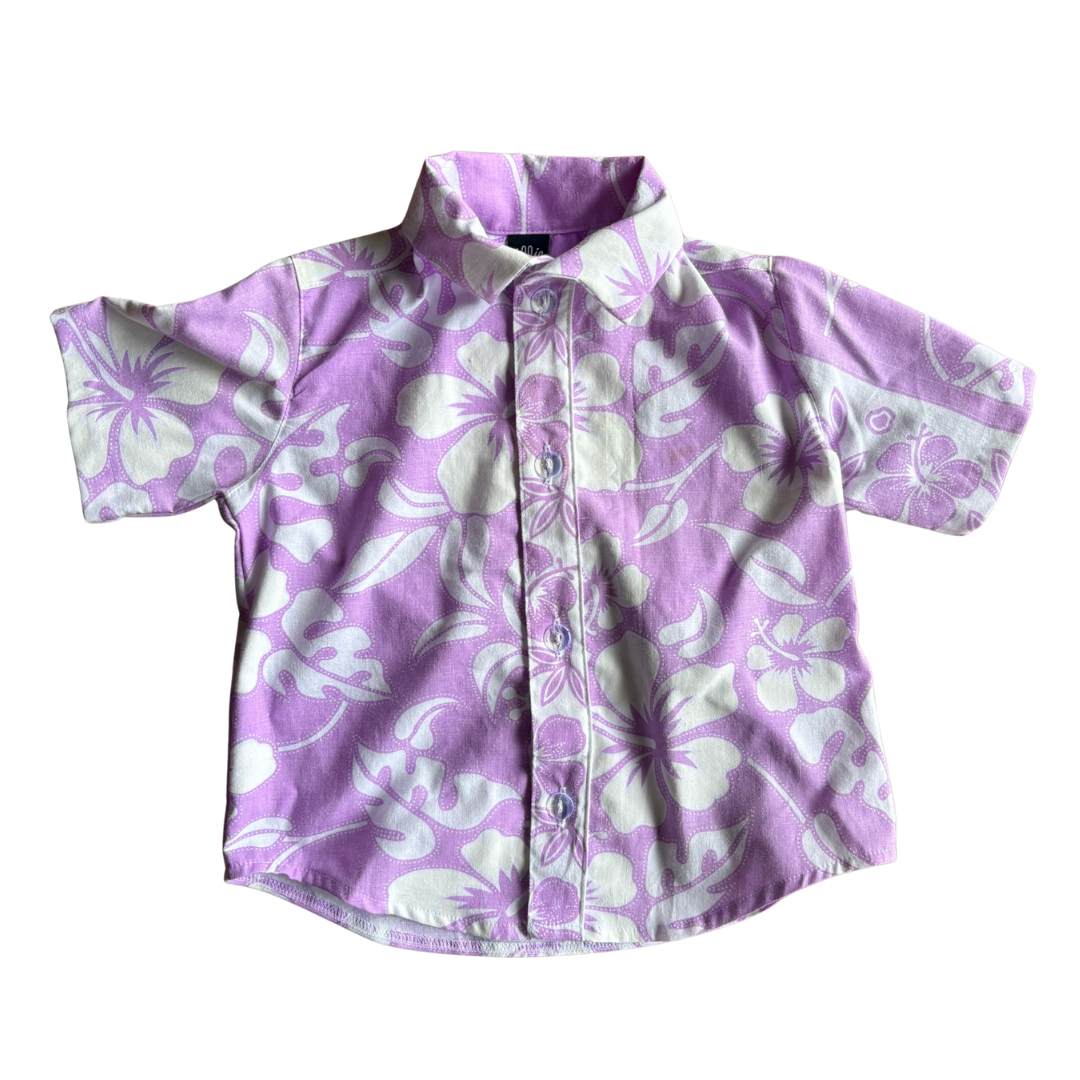 Purple kids party shirt with white floral pattern on a white background